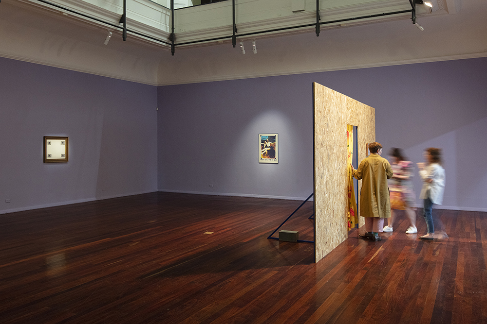 installation view: Agatha Gothe-Snape with Cruthers Collection of Women's Art - Trying to find comfort in an uncomfortable chair, Perth Institute of Contemporary Art, Perth, 2019, showing left to right on walls: Agatha Gothe-Snape, Exit Strategies, 2018-19; Ann Newmarch, Women Hold Up Half The Sky, 1978; floor: Agatha Gothe-Snape, Certain Situations/EXPRESSION CURTAIN, 2013