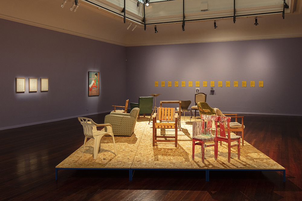 installation view: Agatha Gothe-Snape with Cruthers Collection of Women's Art - Trying to find comfort in an uncomfortable chair, Perth Institute of Contemporary Art, Perth, 2019, showing on platform: Agatha Gothe-Snape, Trying to find comfort in an uncomfortable chair, 2019; left to right on walls: Agatha Gothe-Snape, Giles Hohnen, Helen Eager, Narelle Jubelin