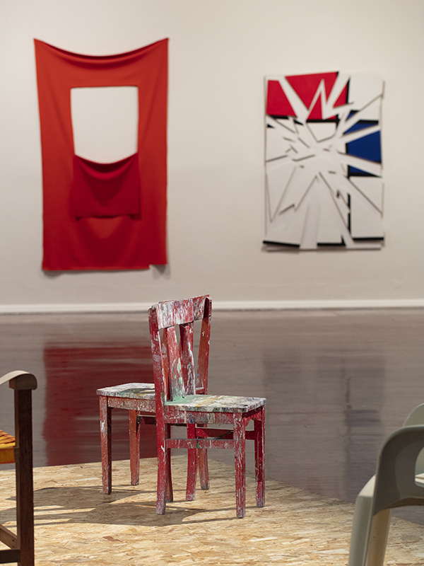 installation view: Agatha Gothe-Snape with Cruthers Collection of Women's Art - Trying to find comfort in an uncomfortable chair, Perth Institute of Contemporary Art, Perth, 2019, showing on platform: Agatha Gothe-Snape, Trying to find comfort in an uncomfortable chair, 2019; left to right on wall: Elizabeth Newman, Untitled, 2005, Maria Kozic, Master Pieces (Mondrian), 1986