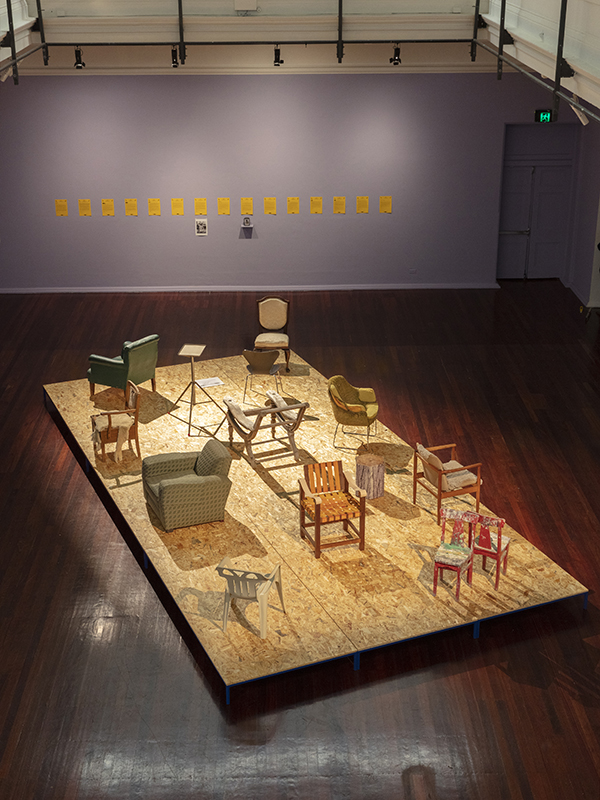 installation view: Agatha Gothe-Snape with Cruthers Collection of Women's Art - Trying to find comfort in an uncomfortable chair, Perth Institute of Contemporary Art, Perth, 2019, showing on platform: Agatha Gothe-Snape, Trying to find comfort in an uncomfortable chair, 2019; top on wall: Agatha Gothe-Snape, 14 letters requesting the loan of chairs sent April 2019; bottom on wall, left to right: Helen Eager, Chair - Unfinished business, 1975-, Narelle Jubelin, Series 7 chair by Arne Jacobsen, 2019