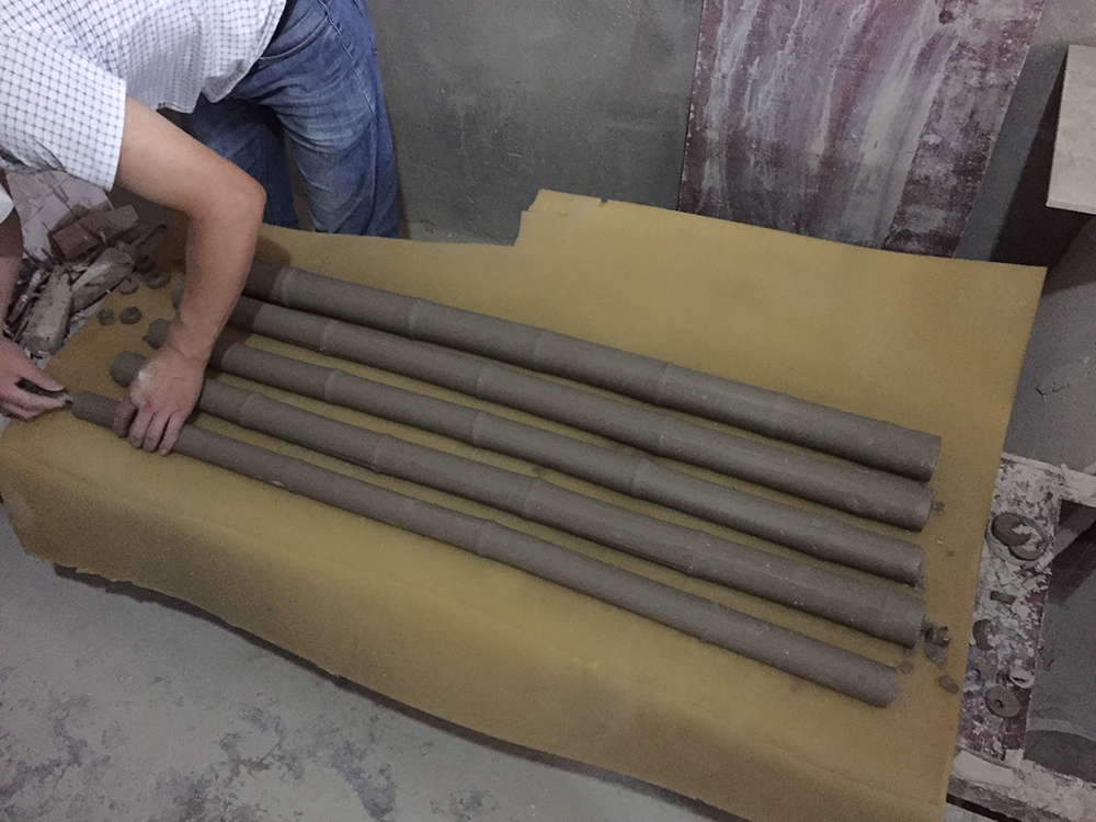 Factory worker checking bamboo casts for Flooded Rose Red Basin - Jinhui Ceramic Sanitary Ware Factory near Wuchangzhen, Sichuan Province, China
